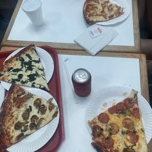 three slices of pizza on paper plates
