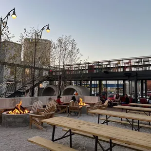 a group of people sitting around a fire pit