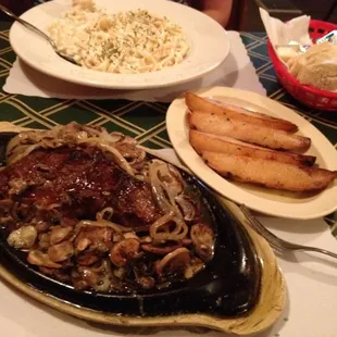 New York strip cooked medium and smothered with onions and mushrooms. The roasted garlic potatoes, and my wife's fettuccine.