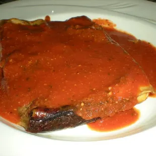 a piece of meat covered in sauce