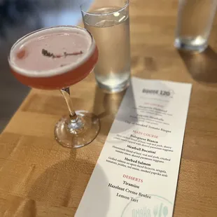a drink and a menu on a table
