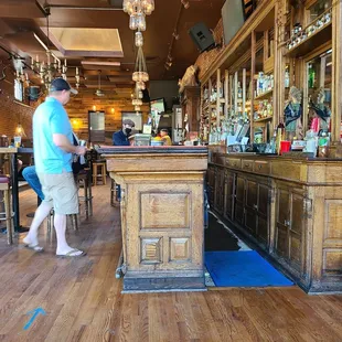 a man walking past a bar