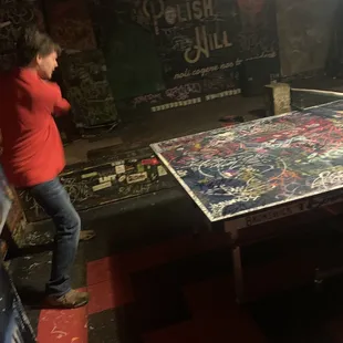 a man playing ping - pong