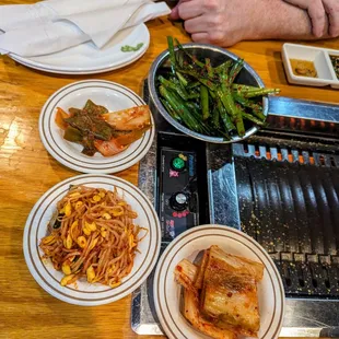 Banchan (Korean side dishes) included with our Combo A ($59.99). Spicy chives, pickled pepper and onion, cold mung bean sprouts, kimchi.