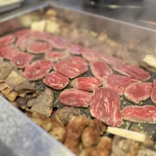 meat being cooked on a grill