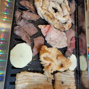 a variety of food on a grill