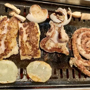 a variety of food on a grill