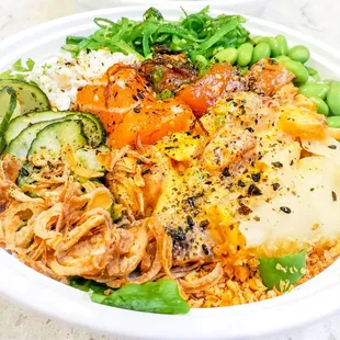 Large poke bowl over sushi rice with classic salmon, spicy aioli ahi, and all the sides and toppings. IG: @take.a.bite.with.me