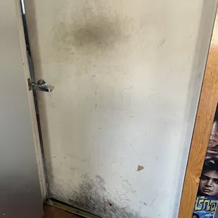 Inside of the restaurant, bathroom door... That may have never been cleaned.