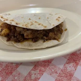 Potato and chorizo taco on flour tortilla