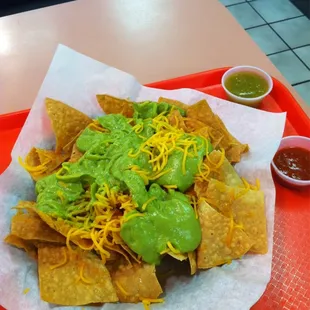 Chips with cheese, guac, red &amp; green sauces = heaven