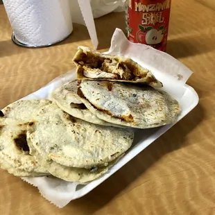 a plate of flatbreads and a can of soda