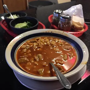 a bowl of soup and a plate of bread