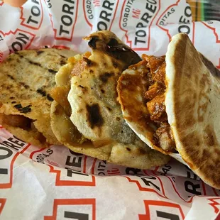 Gorditas, center is grilled corn gordita and far right is flour gordita.