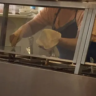 The same hands that give out change, make the food without gloves.