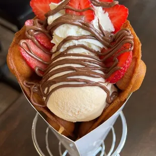 a waffle topped with chocolate and strawberries