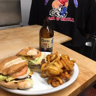 a plate of food and a bottle of beer