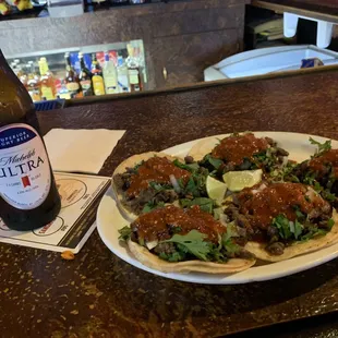 a plate of food and a bottle of beer