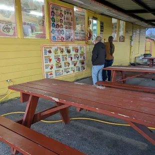 Eating area, Cream Corn Stand across the taco truck
