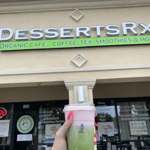Outside with a Matcha Tea with almond milk and Strawberry Mango foam!