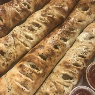 a variety of breadsticks and condiments