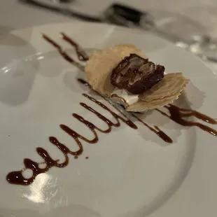 a dessert with chocolate sauce on a white plate