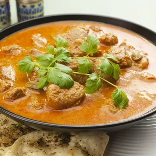 a bowl of soup and pita chips