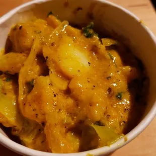 Aaloo achar ($5), vegan by default. Delicious cold potato salad w/spices &amp; mustard oil. Get this.