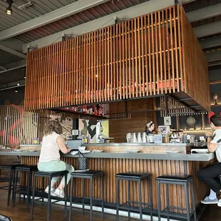 two people sitting at a bar