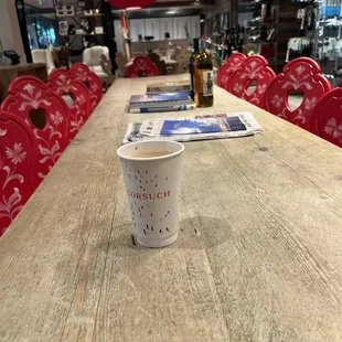a wooden table and red chairs