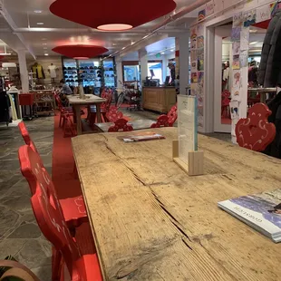 a wooden table and red chairs