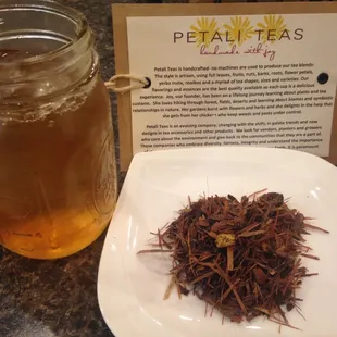 a jar of tea next to a plate of tea