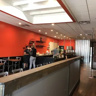 a couple of people standing in a restaurant