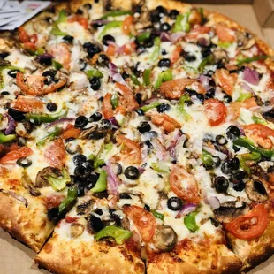 The &quot;Veggies Lover&quot; pizza topped with mushrooms, black olives, green bell peppers, red onions, &amp; Roma tomatoes.