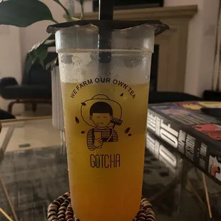 Mango green tea with mango popping boba