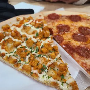 two slices of pizza on a paper plate