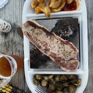 Black Stone strip steak, French fries and fries brussel sprouts
