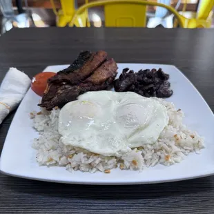 a plate of rice, meat, and an egg