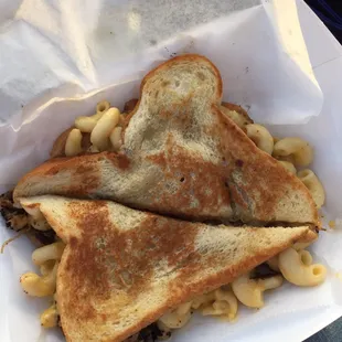 a grilled cheese sandwich with macaroni and cheese