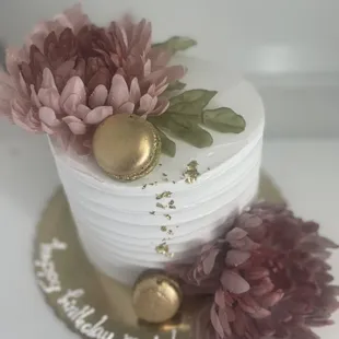 a three tiered cake decorated with flowers