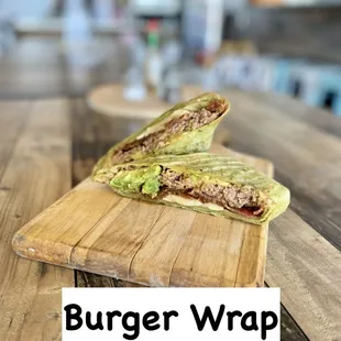 a burger wrap on a cutting board