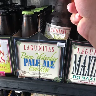 a hand holding a bottle of beer