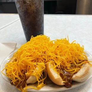 two hot dogs with cheese on them