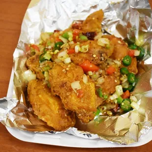 a plate of fried chicken and vegetables
