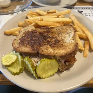 a grilled sandwich and french fries