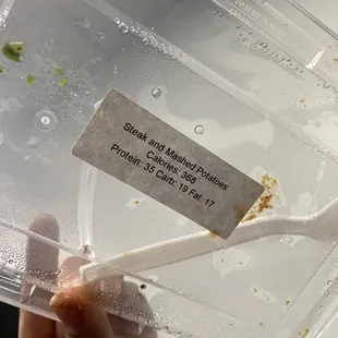 a plastic container with a fork in it