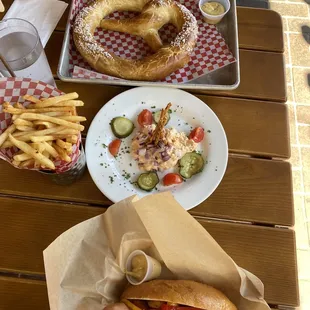 Hot dog pretzel Camembert dip French fries