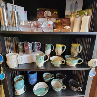 a shelf full of pottery