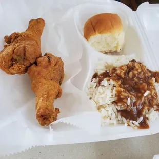 Fried chicken legs, rice and gravy, roll