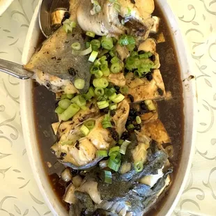 Steamed catfish with tofu in black bean sauce and spring onions